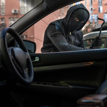 supergroup dealerships image of a person breaking into a car window